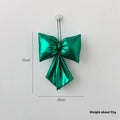 Christmas decorative bowknot with bright leather finish in red colour on a tree branch