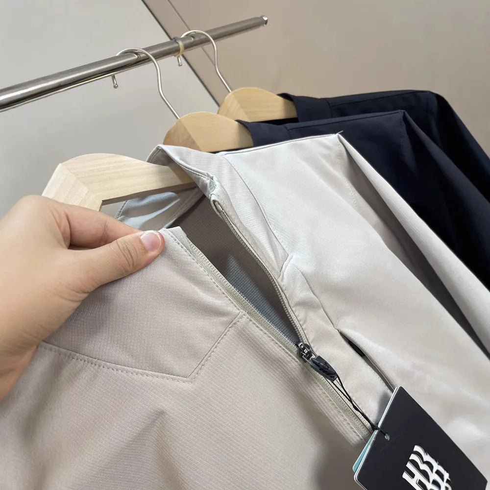 Man wearing a milky white stand collar casual jacket with long sleeves and a straight hem.