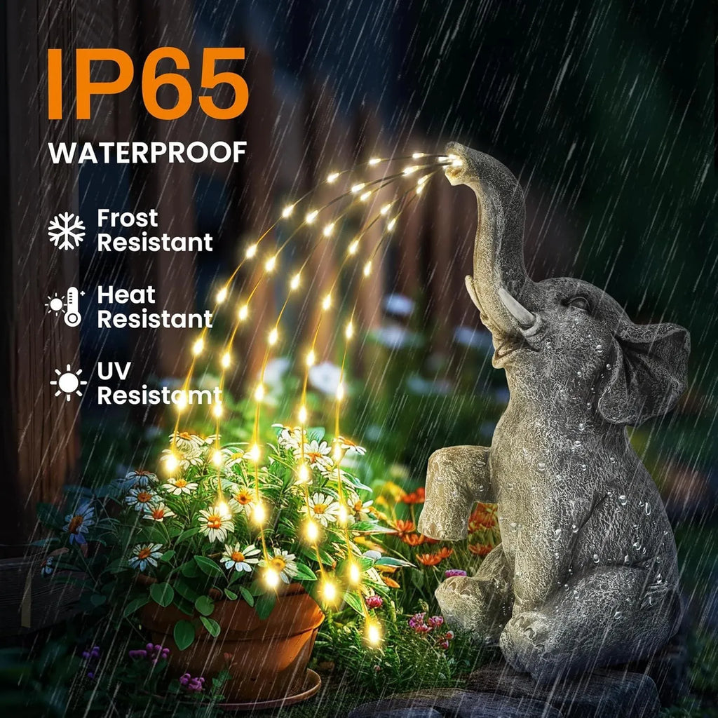 Grey resin elephant garden statue with solar-powered LED lights on its back.