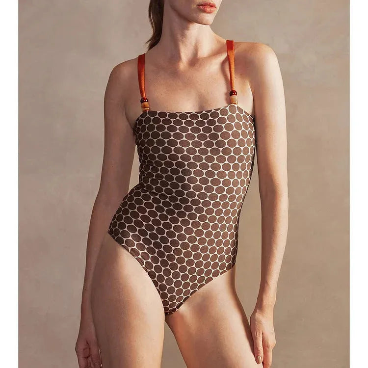 Women's one-piece swimsuit with matching wrap skirt in dot pattern design