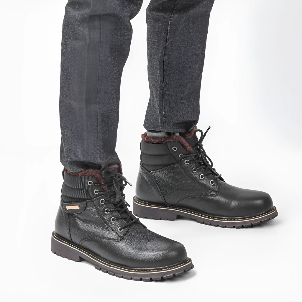 Pair of black plus size men's cowhide leather snow boots with fleece lining, mid-calf height and rubber sole.