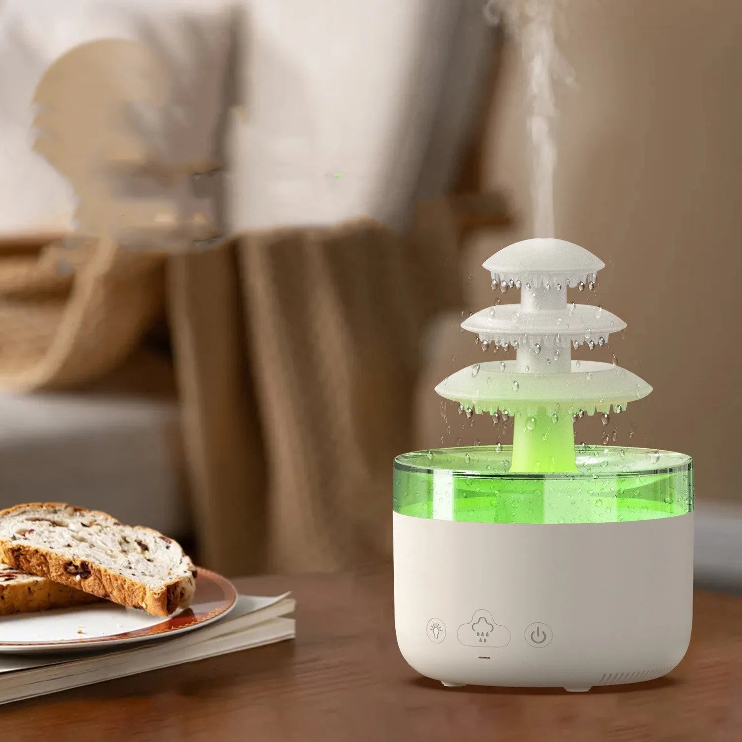 White cloud rain design ultrasonic air humidifier and essential oil diffuser with colourful LED lights on a table.