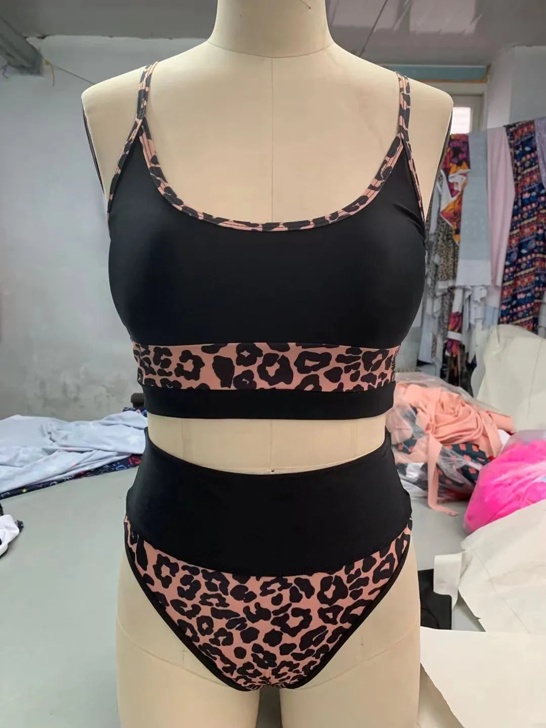 Women's white and leopard print high waist split bikini swimsuit laid flat.