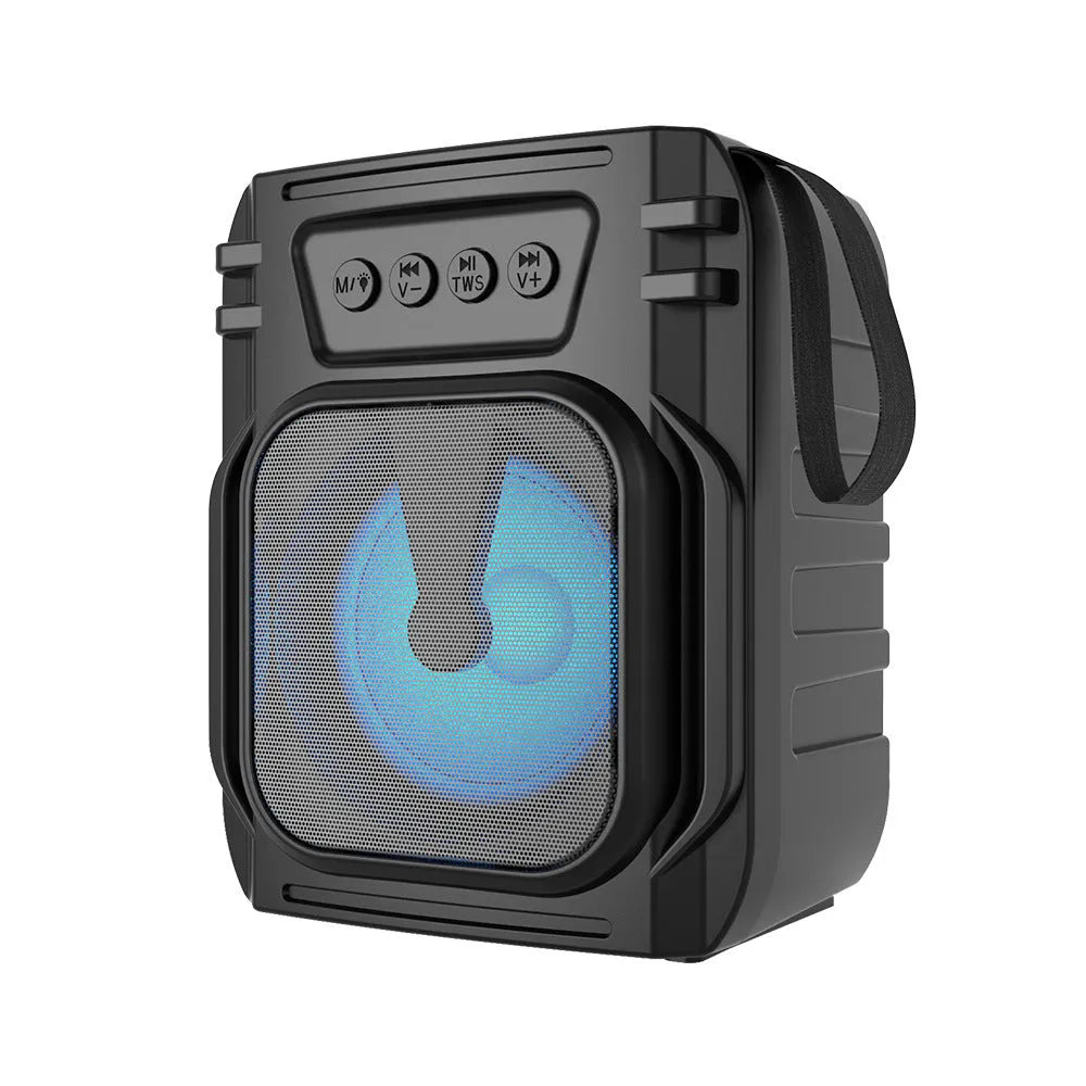 Compact portable Bluetooth speaker with USB charging cable on a table.