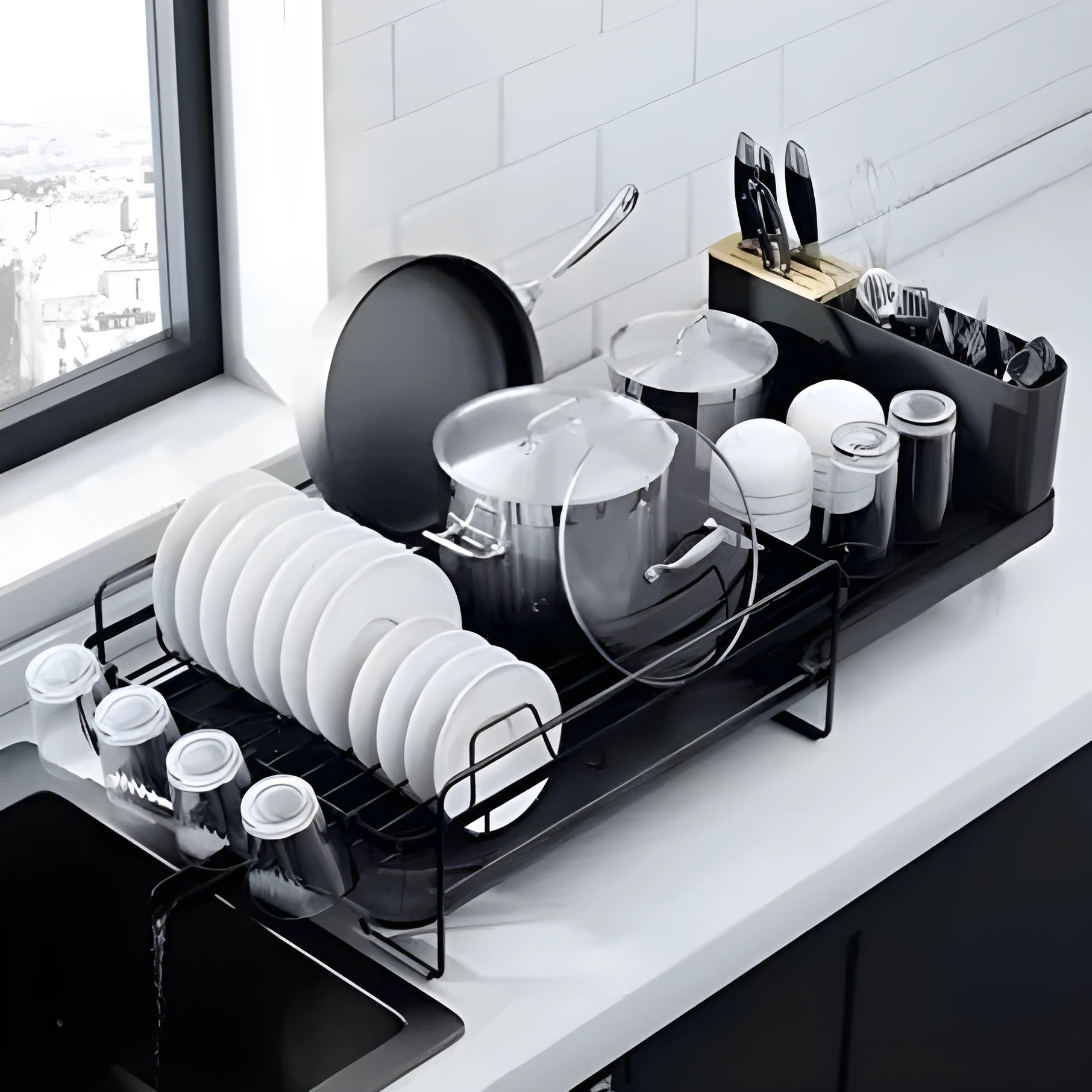 A retractable, foldable carbon steel dish rack for draining cutlery, knives, forks and cups on a kitchen countertop.