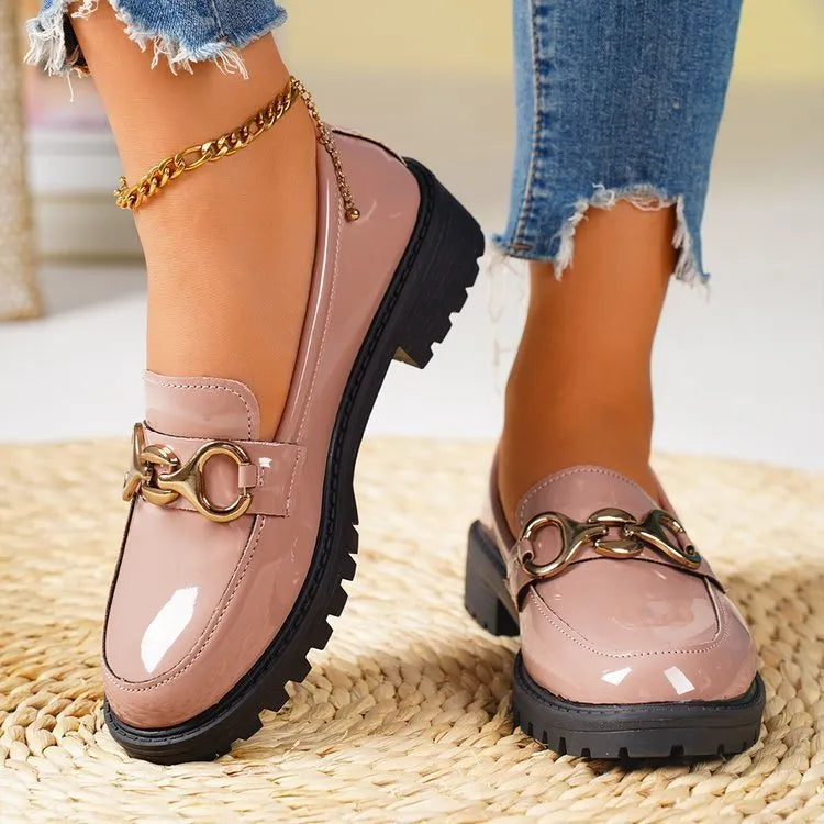Women's black chunky heel pumps with round toe, thick rubber soles, and metal decorative accents