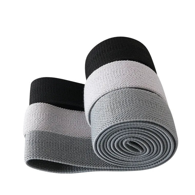 Three polyester cotton and latex silk resistance bands 200 x 4 cm in blue pink and purple on a flat surface