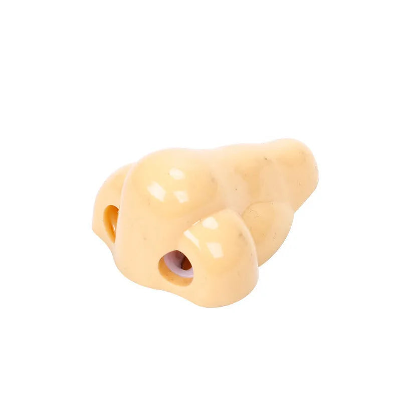 Flesh colour plastic manual pencil sharpener with big nostril, showing geometry shape.