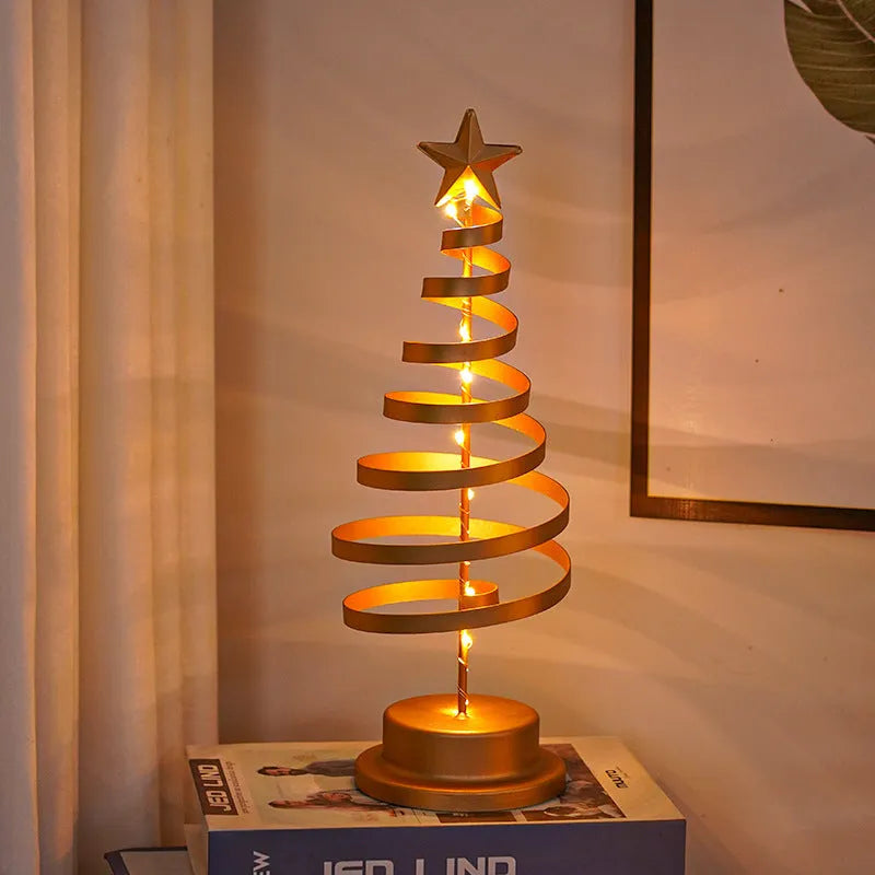 Wrought iron metal LED Christmas tree spiral light with warm white illumination on tabletop
