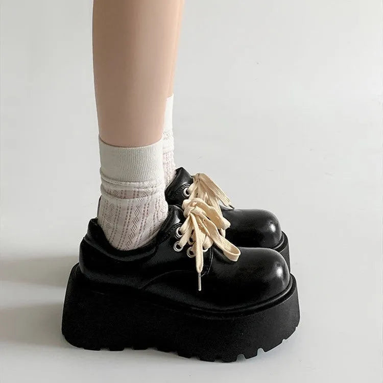 Matte black women's lace-up ankle boots with a chunky 8cm heel and buckle.