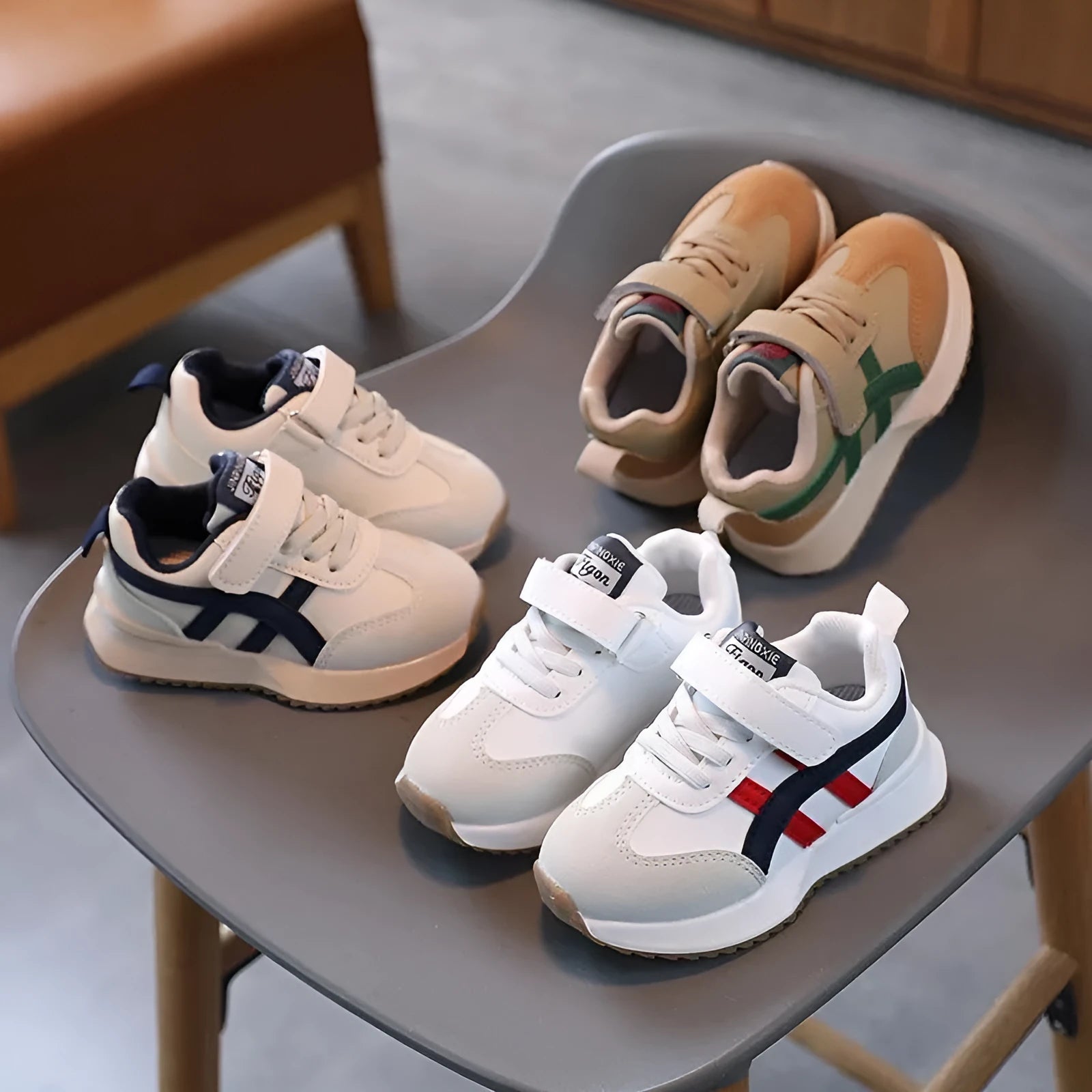 Children's white velcro sneakers with synthetic leather upper and rubber sole on a neutral background.
