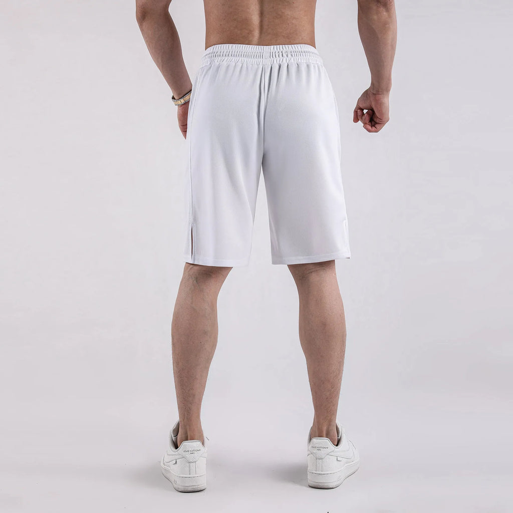 Man wearing loose-fit black quick-dry mesh shorts for casual summer sportswear.