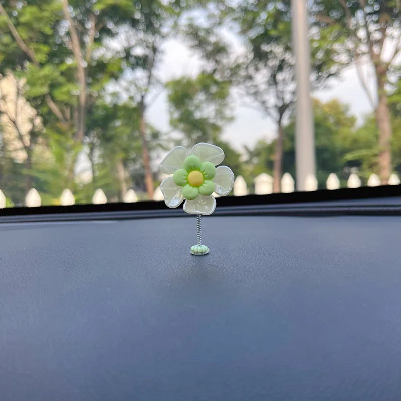Small colourful plastic swing car decoration for dashboard or mirror.