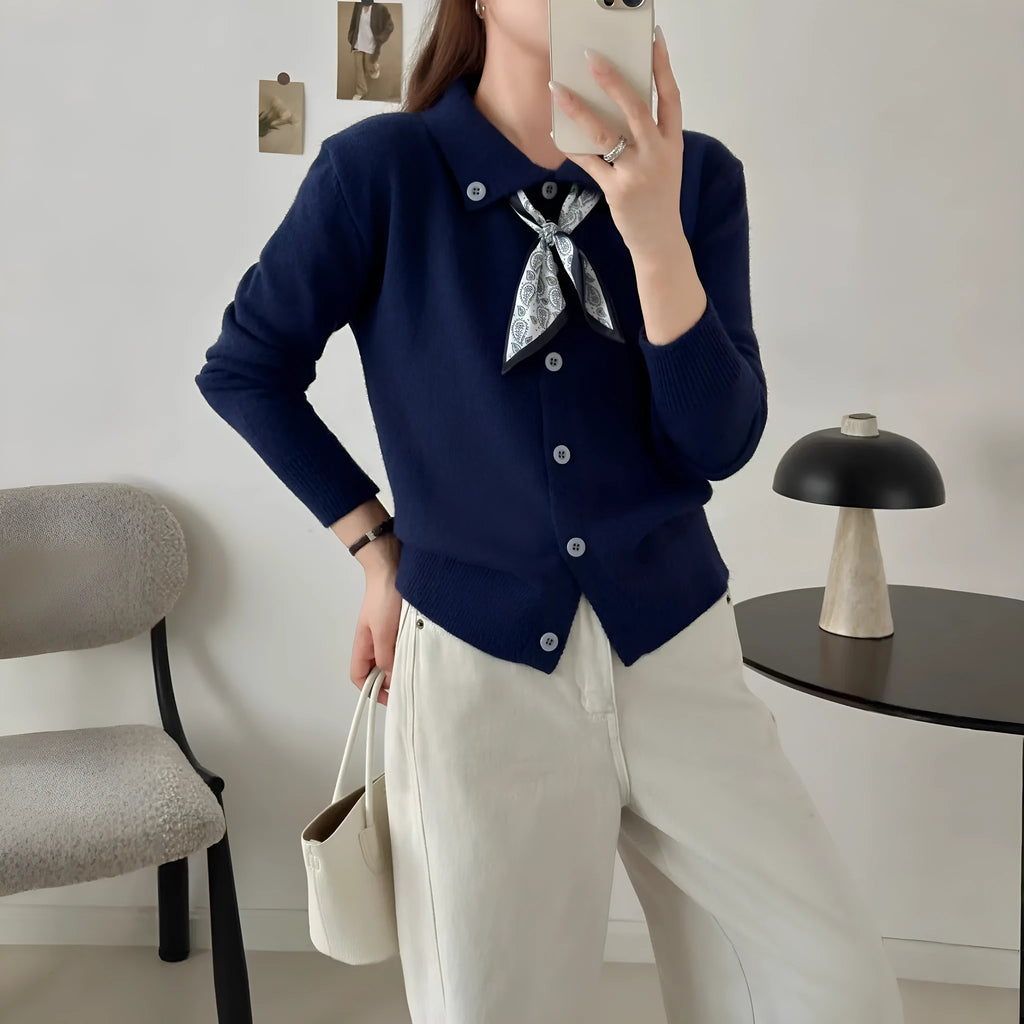 Milky white cardigan sweater with a lapel scarf collar and spliced knit detailing.