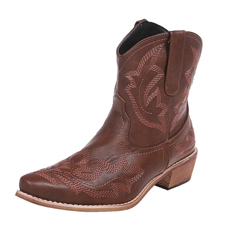 Women's blue embroidered cowboy boots with low wedge heel and pointed toe.