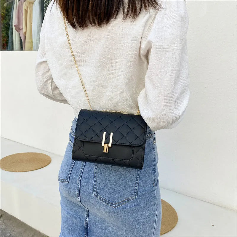 Women's minimalist crossbody bag with diamond lattice chain strap in black, green, or white.