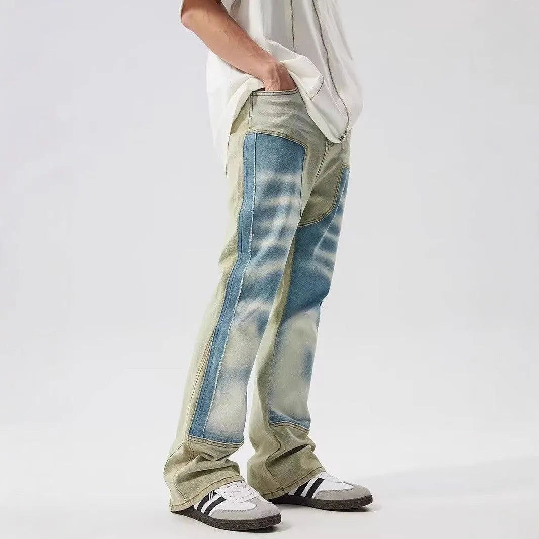 Yellow and blue retro patchwork jeans with splash-ink and distressed detailing on a mid-rise denim fit