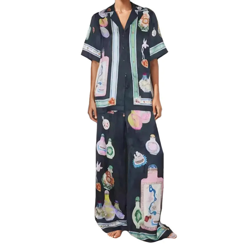Black women's casual set with cartoon print, featuring a cardigan and matching trousers on a hanger.
