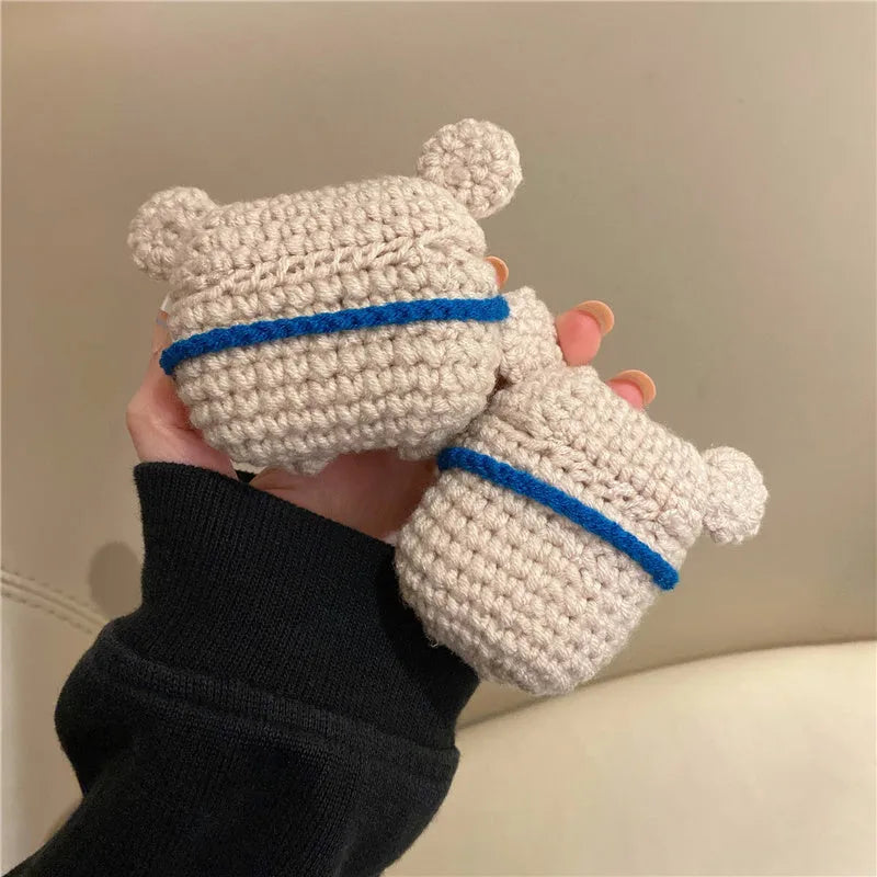 Handmade knitted koala bear backpack-shaped cover for an AirPods charging case.