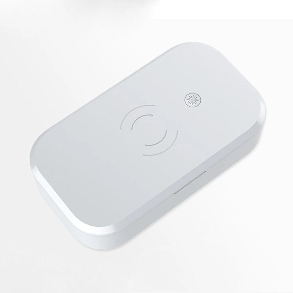 White ultraviolet disinfection box for nail tools with integrated wireless phone charging pad.