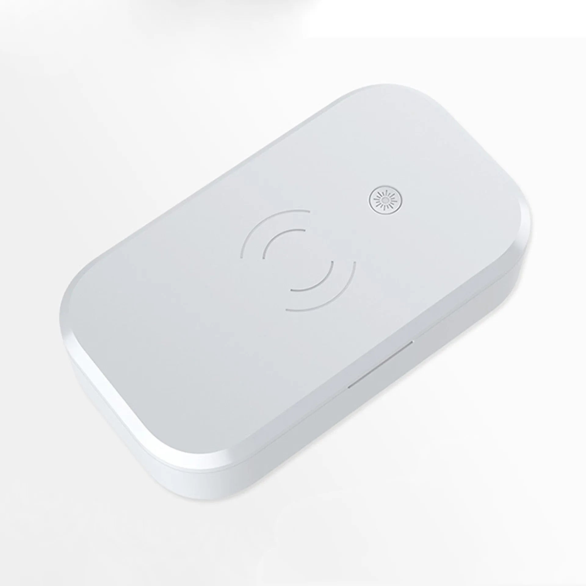 White ultraviolet disinfection box for nail tools with integrated wireless phone charging pad.