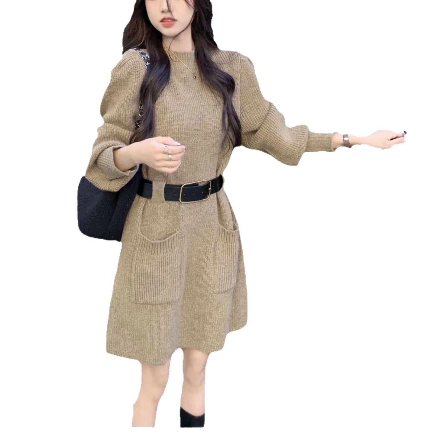Long sleeve loose knitted dress for women in beige with a black belt, shown on a hanger.