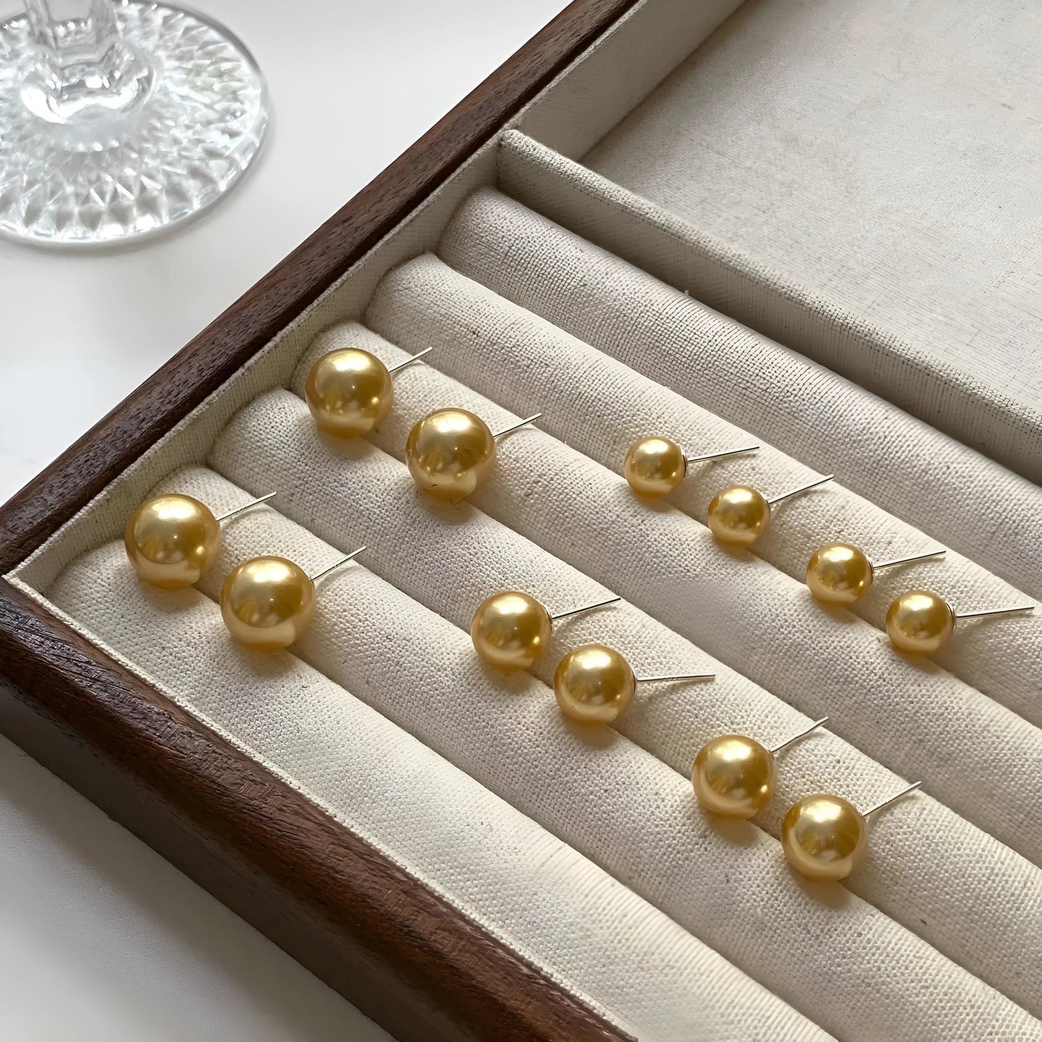 Geometric large pearl stud earrings with an eight-point star detail on a silver setting.