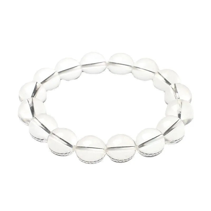Natural white crystal bead bracelet with geometric design on a wrist.