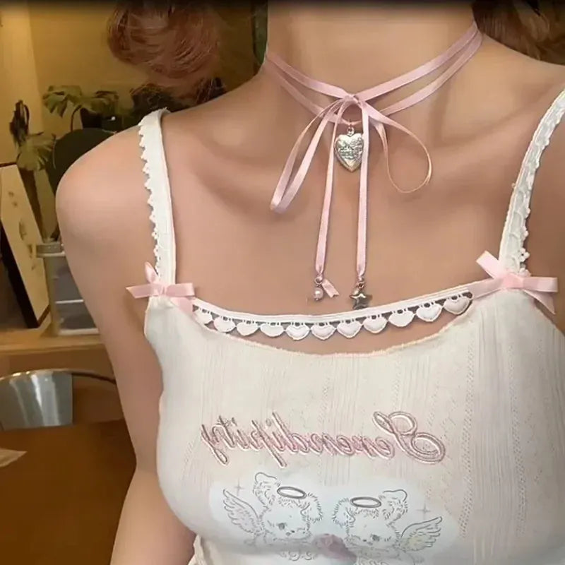 Close-up of a women's alloy fashion necklace with a ribbon love pendant on a dainty clavicle chain.