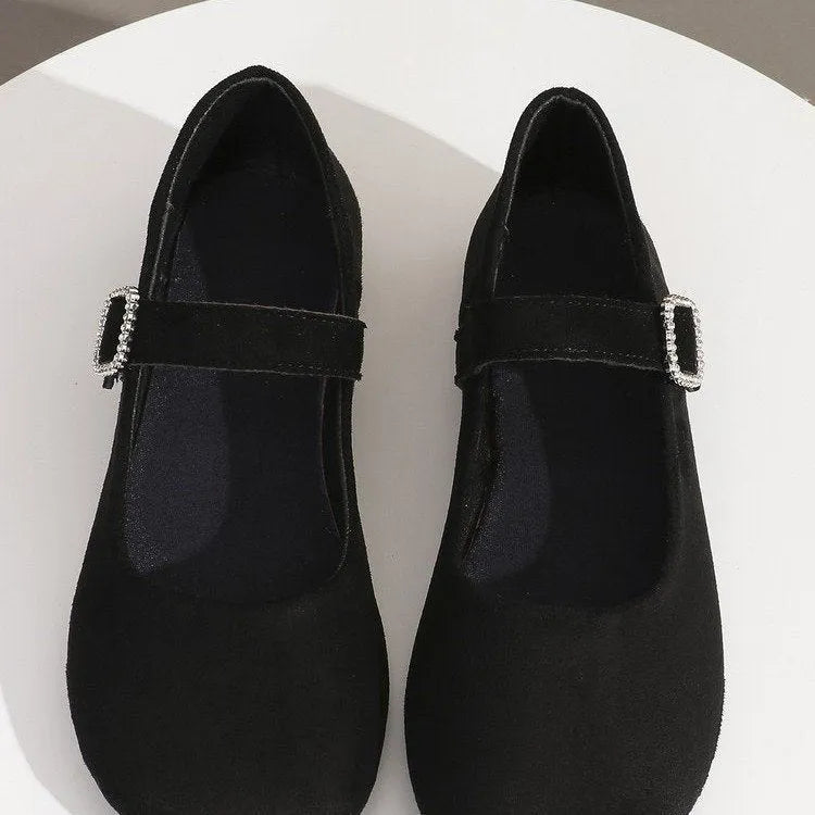 Black canvas low-top flat fisherman shoes with a rubber sole on a plain background.