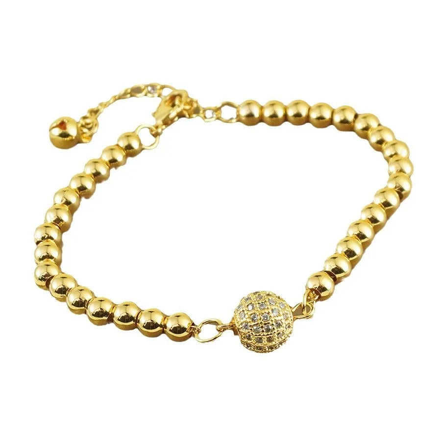 Close-up of a women's heart-shaped copper bracelet with a single round zircon stone, Arabic style.