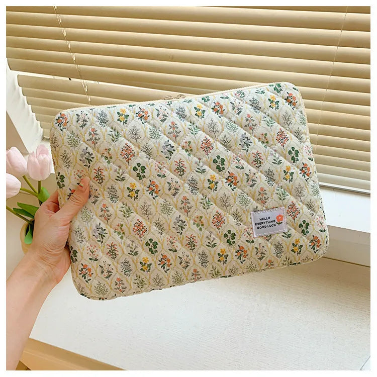 Women's printed floral cloth laptop bag shown in green flower pattern, available in small, medium, and large sizes.