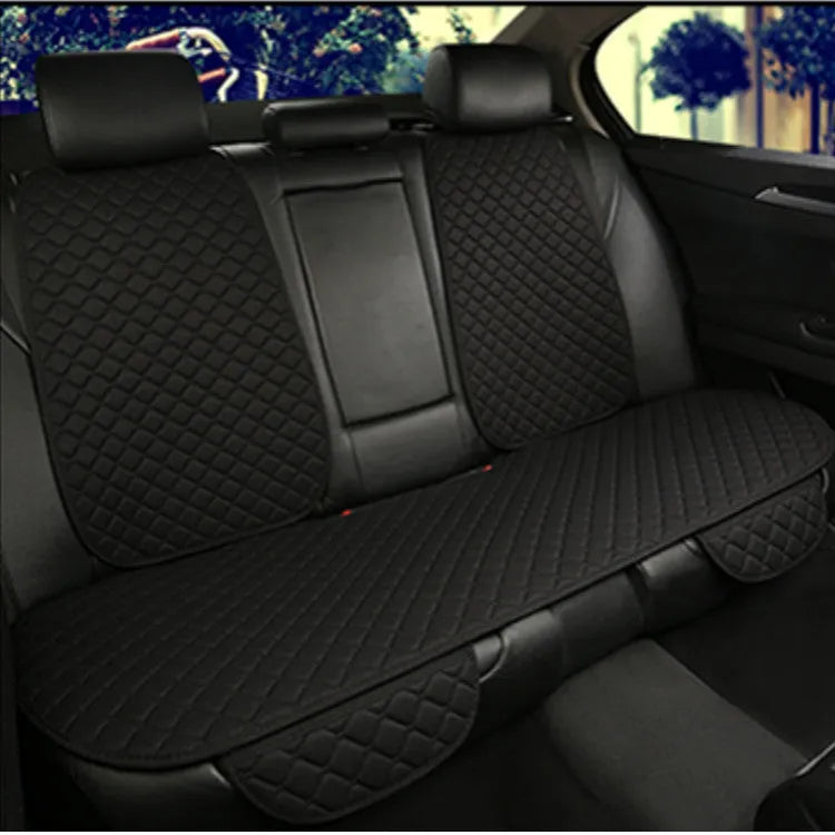 Linen universal car seat cushion in black with decorative red thread pattern on base.