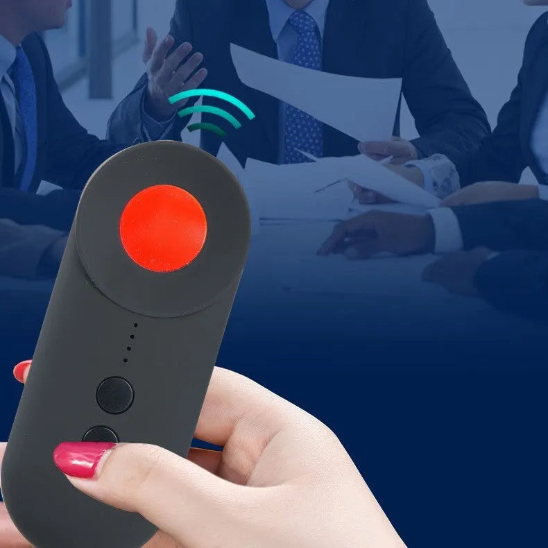 Black portable GPS and hidden camera detector with USB cable on a flat surface.