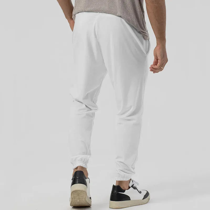 Men's grey straight-leg casual track sweatpants with elasticated waist on a neutral background.