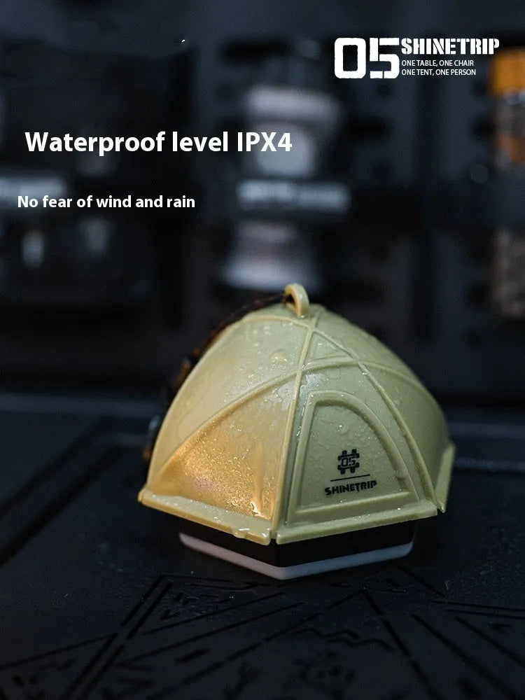 Dark green camping tent light with analog dimmer dial showing IPX4 waterproof rating.