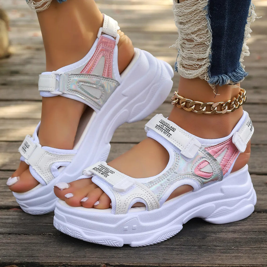 Women's black Roman platform sandals with secure strap design on white background