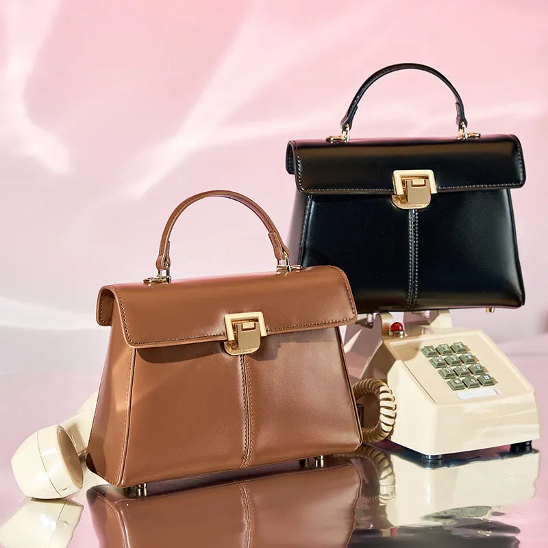 Dark brown genuine leather women's shoulder bag with a clasp, showing its horizontal square shape and shoulder strap.