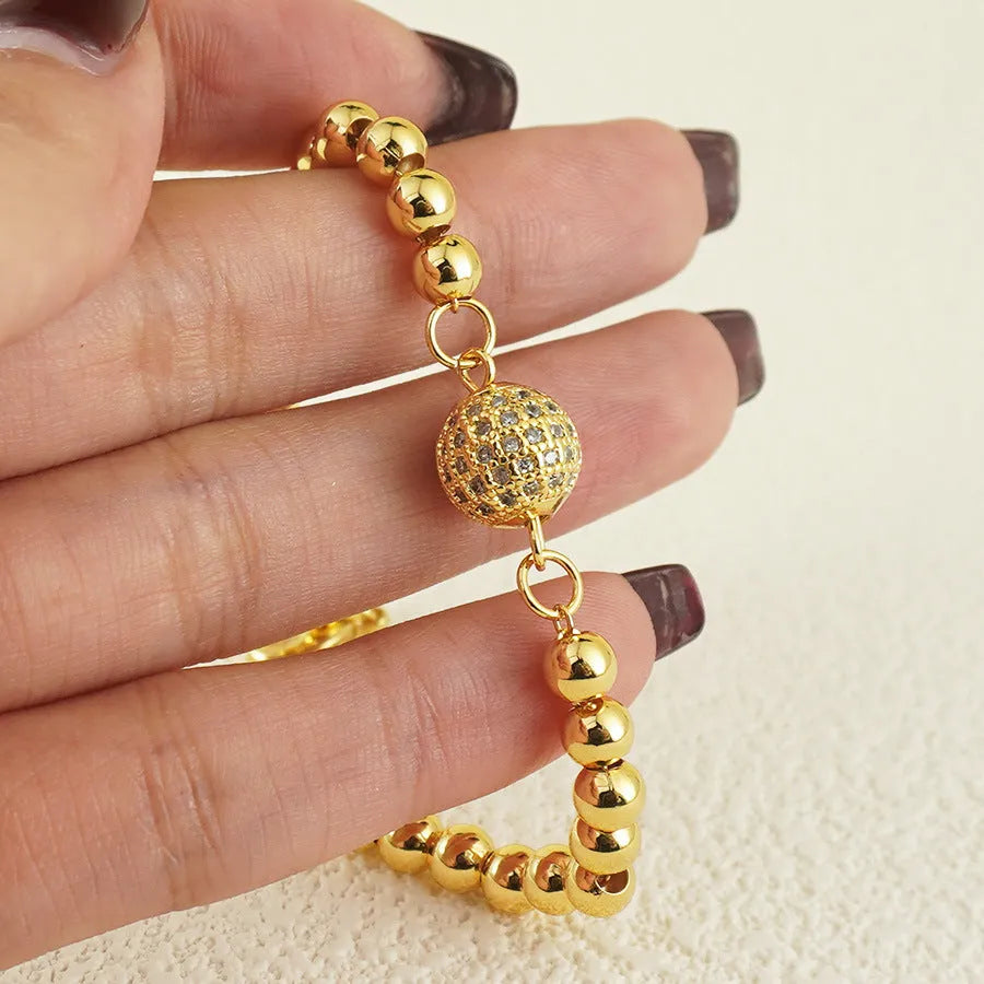 Close-up of a women's heart-shaped copper bracelet with a single round zircon stone, Arabic style.