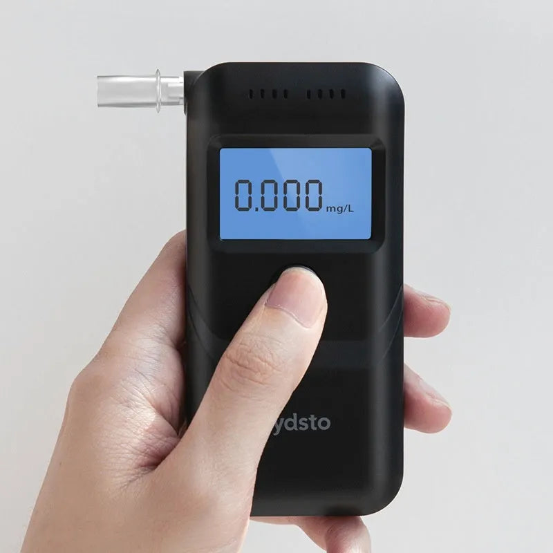 Black household alcohol tester with digital display for breath alcohol measurement and drunk driving checks