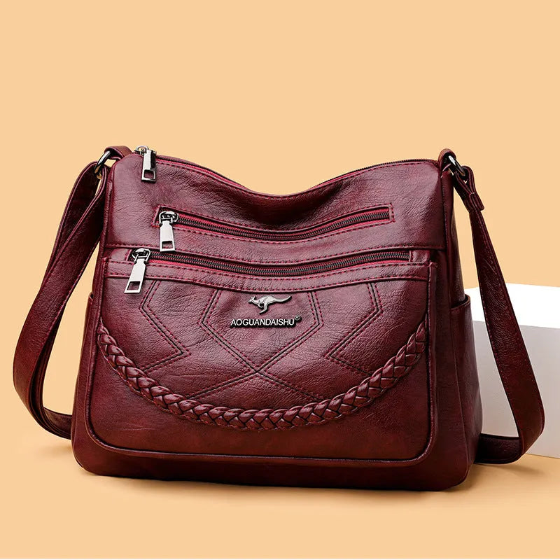 Soft leather crossbody shoulder bag in horizontal square design with zippered internal pocket