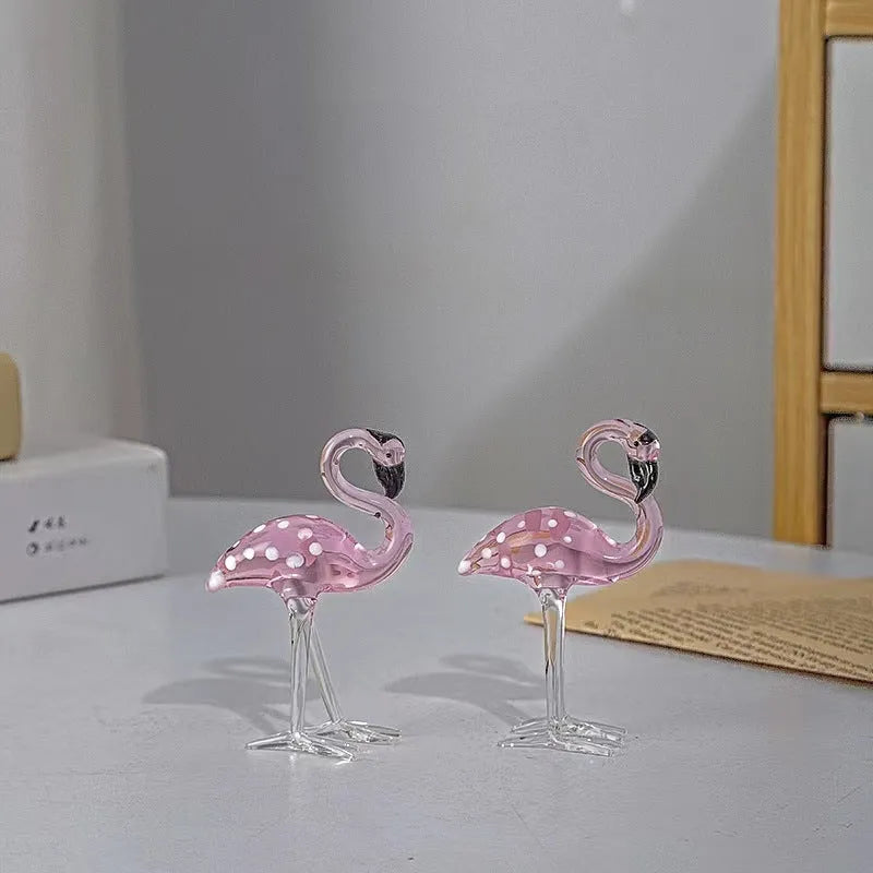 Pink crystal flamingo decorative figure on a table in modern style.