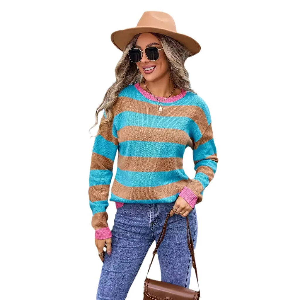 Women's loose blue acrylic sweater with stripes, round neck, and long sleeves on a hanger.