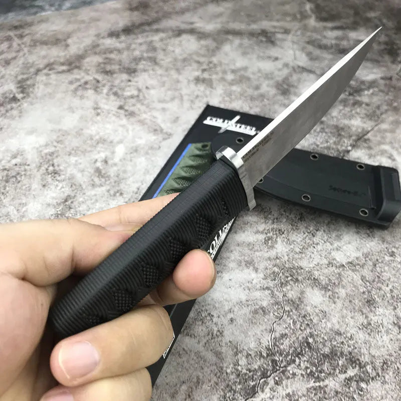Mini straight knife with 440C steel blade, ABS handle, and holster on outdoor surface