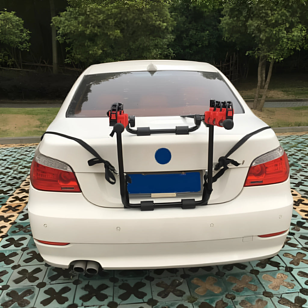 Black and red trunk mounted bike rack with iron frame and sponge padding, showing tie rope and pull belt fastening options.