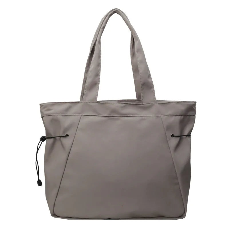 Soft Oxford cloth folding tote bag in five colour options showing shoulder carry design
