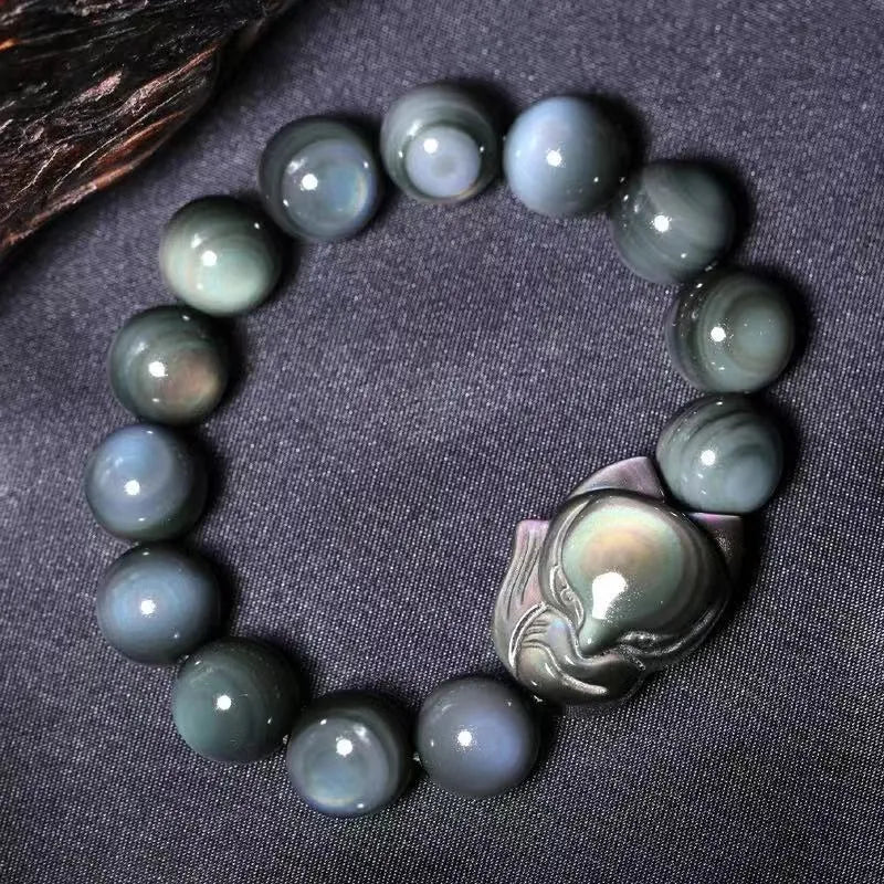 Black obsidian fox carved bracelet showing detailed animal design on polished gemstone