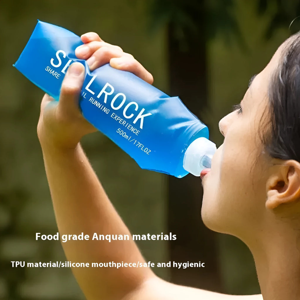 Grey portable water filter straw with textured grip and long flexible silicone tube, shown with a carabiner clip.