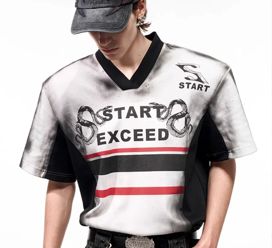 V-neck short sleeve top with snake letter pattern print and padded shoulders.