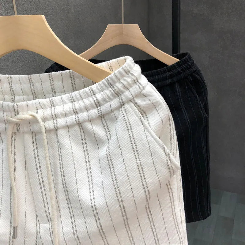 Black and white striped men's casual fleece-lined shorts with an elastic waistband.